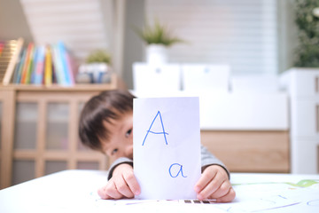 Kindergarten boy playing with flash cards , Asian children learning English with flash cards, Teach young kids English at home, Child at home, kindergarten closed during the Covid-19 health crisis
