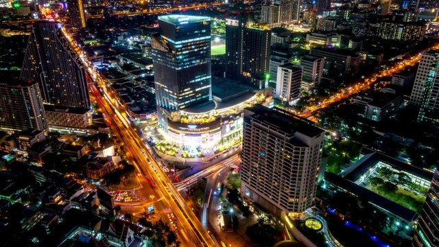 Bangkok business district city center above Samyan area and traffic, with buildings and skyscrapers, during night, zoom out � Time Lapse