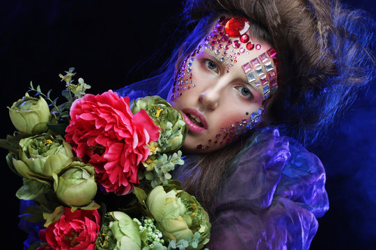 woman in creative image with big flowers.