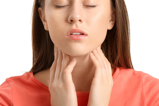 Young woman checking thyroid gland on white background, closeup