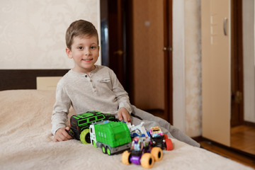 A little boy sitting on a bed