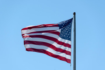 US flag on blue sky