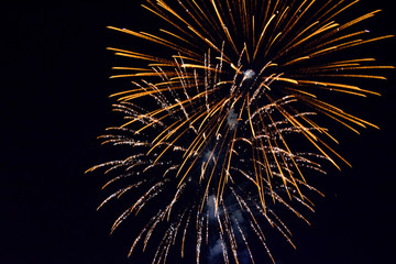 Festive salute in night sky. Explosions of fireworks and pyrotechnics in the sky.