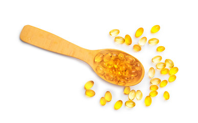 Spoon with fish oil capsules on white background