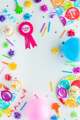 A vertical top down view of various birthday party items in a border for a birthday girl.
