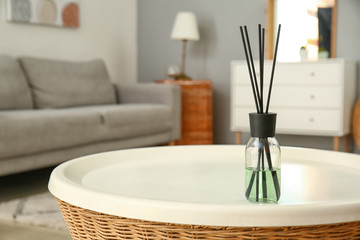 Reed diffuser on table in room