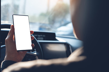 Man using phone inside a car