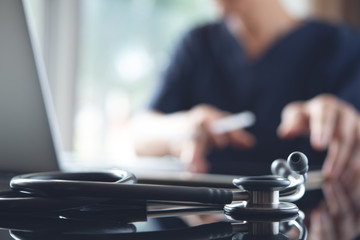 Doctor working on laptop computer