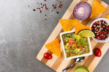 Traditional Mexican Latin American Salsa sauce and Guacamole on wooden board.