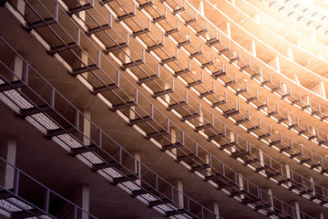 Fragment of unfinished multi-level parking, residential building or commercial property. Tinted background of concrete structures for design on architectural, construction topics
