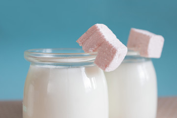 pink marshmallows and milk on a blue background