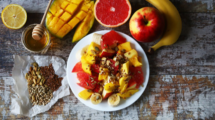 Selective focus. Super fresh nutritious fruit salad with seeds. Salad with mango, banana and grapefruit. Vitamin food. Healthy food.