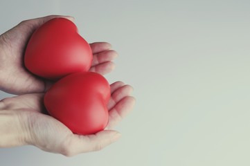 Woman hand holding red heart, health care, donate and family insurance concept, world heart day, world health day,CSR responsibility, adoption foster family, hope, gratitude, kind, concept