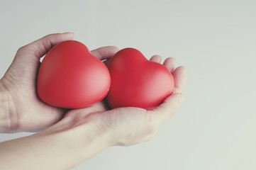 Fototapeta premium Woman hand holding red heart, health care, donate and family insurance concept, world heart day, world health day,CSR responsibility, adoption foster family, hope, gratitude, kind, concept