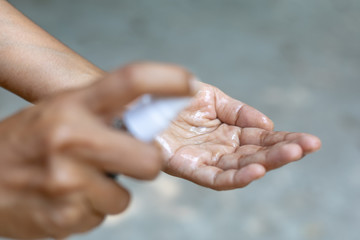 Hand that applying alcohol spray or anti bacteria spray to prevent spread of germs, bacteria and...