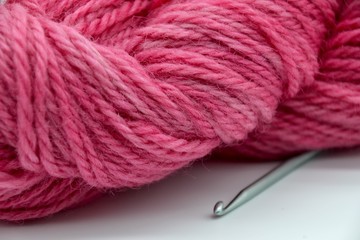 Fototapeta na wymiar Close up view of pink wool and crochet hook