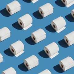 White toilet paper roll on blue background with shadow