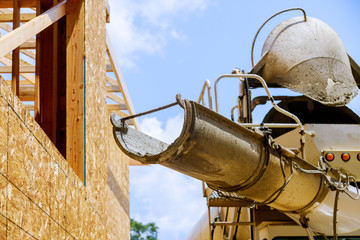 Cement truck mixer pouring cement fresh concrete
