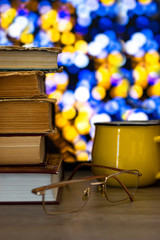 Library of books, time to read with a cup of coffee. Multicolored bokeh