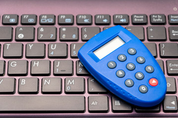 Obraz premium One-time safe password, internet banking token. Close up of digipass (secure remote access and authentication) and computer keyboard 
