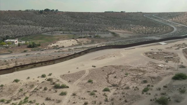 Aerial: El Paso border wall from the USA side that separates Mexico & the USA.