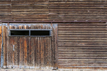 Abandoned weathered barn, close-up view rustic wall.