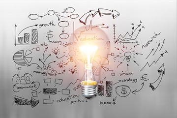 Glowing glass light bulb with a financial illustration