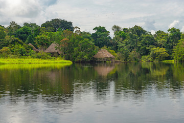 Fototapeta na wymiar Amazon rainforest lodge hotel reflection. The Amazon Region comprise the countries of Suriname, Guyana, French Guyana, Venezuela, Colombia, Ecuador, Peru, Bolivia and Brazil.