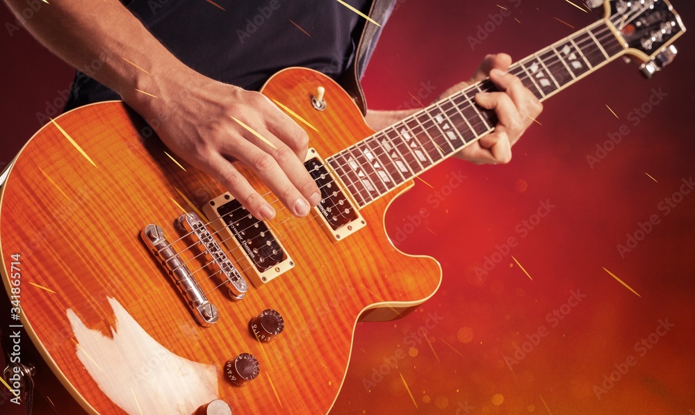 Canvas Prints male hands of the guitarist playing a melody on a wooden acoustic guitar