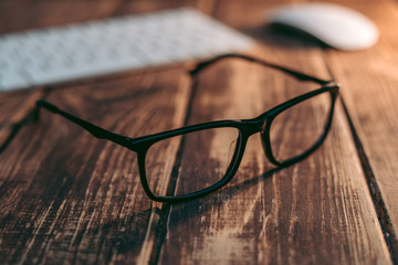 Glasses for sight and vision correction and protection from computer on the wooden table