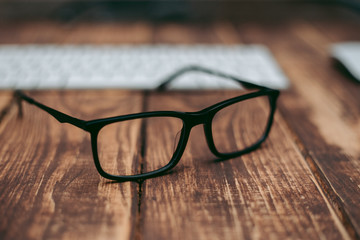 Glasses for sight and vision correction and protection from computer on the wooden table