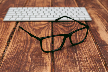 Glasses for sight and vision correction and protection from computer on the wooden table