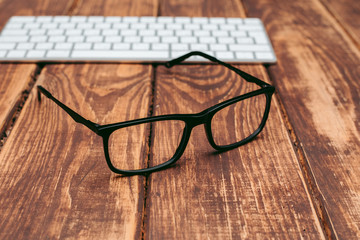 Glasses for sight and vision correction and protection from computer on the wooden table