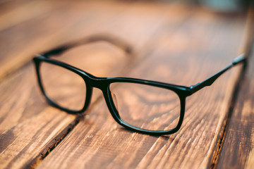 Glasses for sight and vision correction and protection from computer on the wooden table