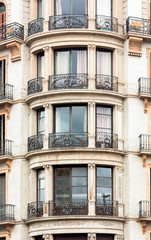 Fototapeta na wymiar Round balconies with ionic pilasters and wrought iron grilles