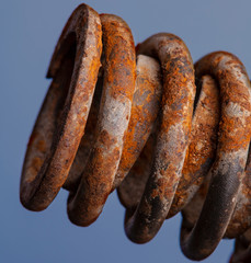 Rusted spring on blue