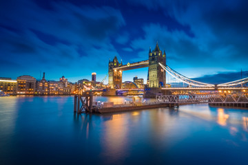 Naklejka na ściany i meble Famous Tower Bridge over themes river London at night London, Aerial view to the illuminated Tower Bridge and skyline of London