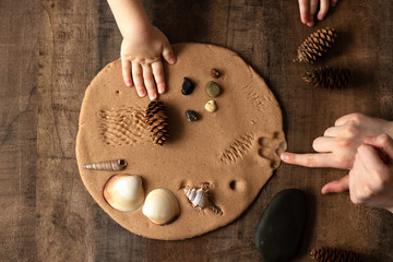 Modeling with salt dough on the kitchen table. Natural materials for the game, the natural composition of the product. Creative development of children in the period of self-isolation