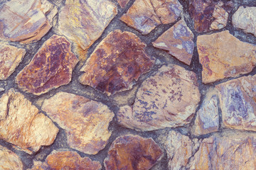 Natural backgrounds of colored stones with round and square shape on the wall, use for outdoors decoration.