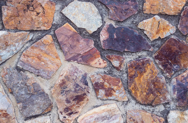 Natural backgrounds of colored stones with round and square shape on the wall, use for outdoors decoration.