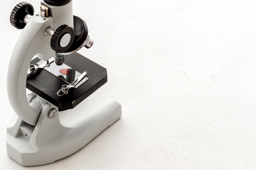 Bood testing with microscope in laboratory. Equipment on white background copy space