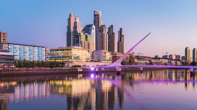 Day to night time lapse view of Puerto Madero including architectural landmark Puente de la Mujer in Buenos Aires, Argentina.