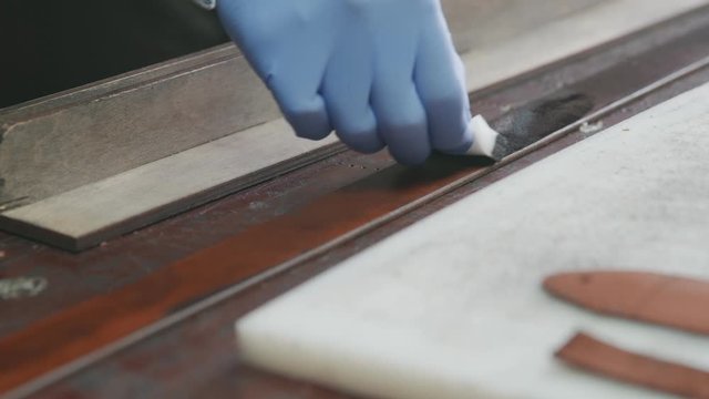 Professional Tanner Applying Black Edge Dye To Leather Belt. Working Process Of The Leather Belt In The Leather Workshop.