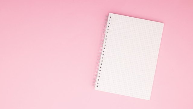 Opened notebook moving on pink background - Stop motion