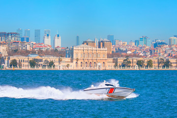Fototapeta premium Coast Guard patrol boat rushing to the rescue on the background Dolmabahce Palace - Istanbul, Turkey