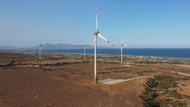 Aerial view of windmills farm for energy production on rice field, Mui Dinh, Ninh Thuan, Vietnam. Wind power turbines generating clean renewable energy for sustainable development