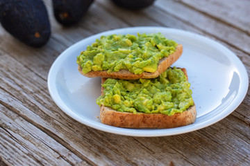 Avocado toast on whole grain sandwich bread. Mashed avocado toasts. Concept of healthy eating, dieting, vegan vegetarian food