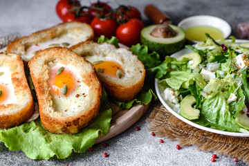 Delicious breakfast with grunts, eggs, avocado and cherry tomatoes