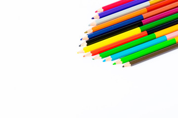 colored pencils over white background
