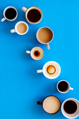 Many cups of coffee on blue desk top view space for text